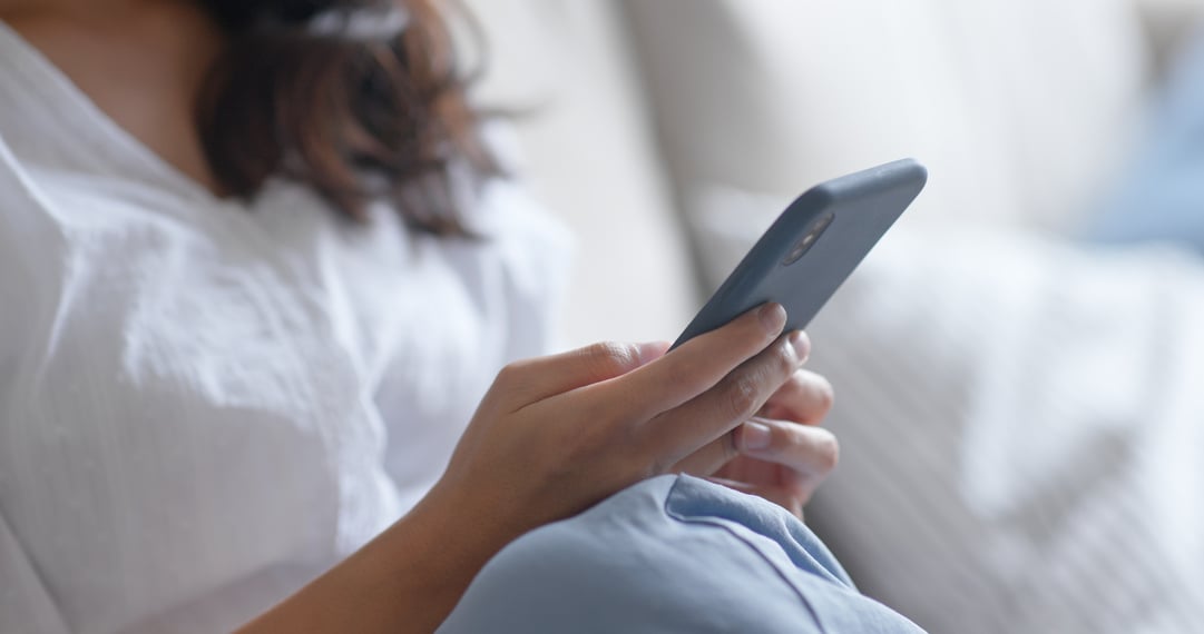 Woman Using Smartphone at Home